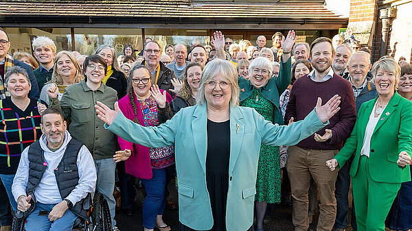 Lorna in front of a crowd of Lib Dems