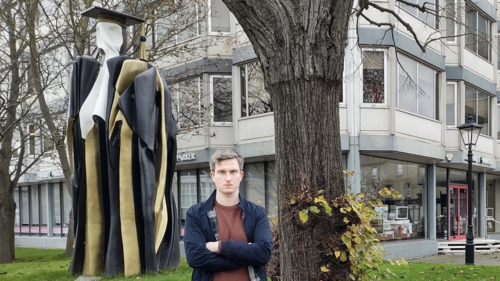 Anthony in front of the Don Statue looking unhappy